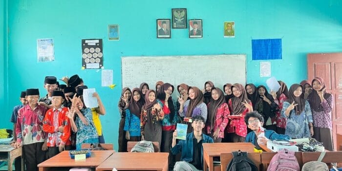 A group of people in a classroom AI-generated content may be incorrect.