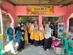 A group of women standing in front of a store Description automatically generated